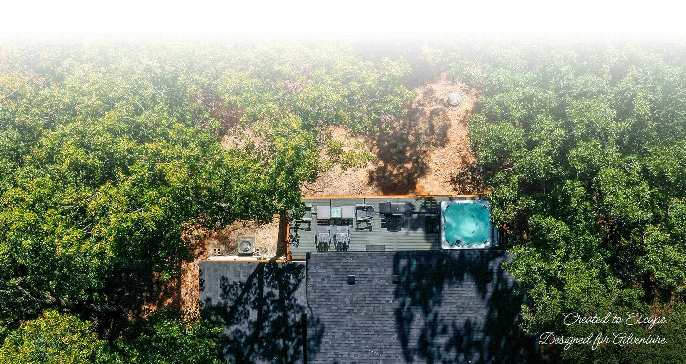 Arial view of home back deck and trees Arial view of home back deck and trees